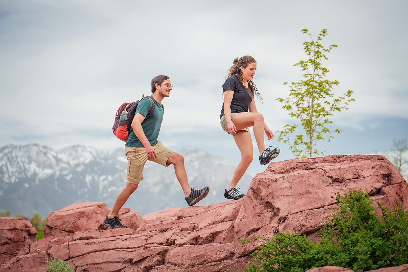 hikers hiking on red rocks