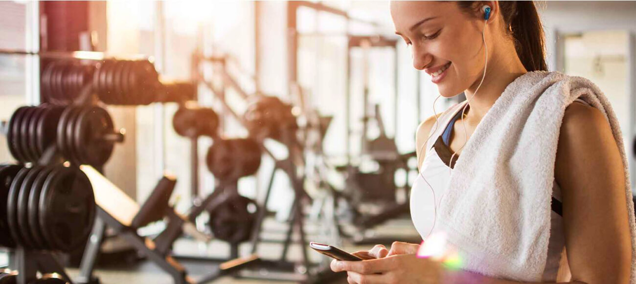 woman wearing earphones at gym