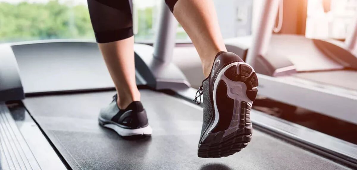 woman running on treadmill at gym