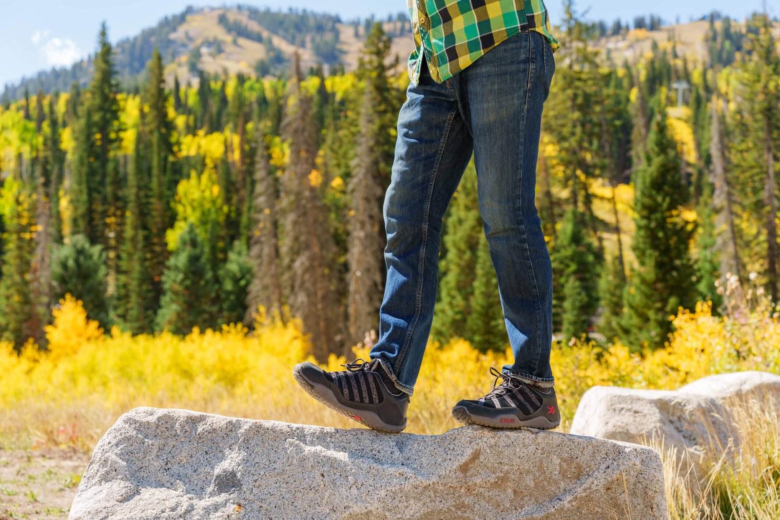 Man standing on rock wearing KURU CHICANE trail hiking shoes.